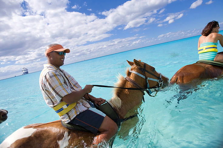 One of the best ways to enjoy this tropical island is by horseback right into the surf.